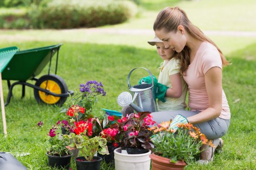 Two gardeners discussing a clearance in a terrace back garden