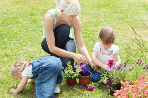 Trimmer using specialized tools on a flowering hedge